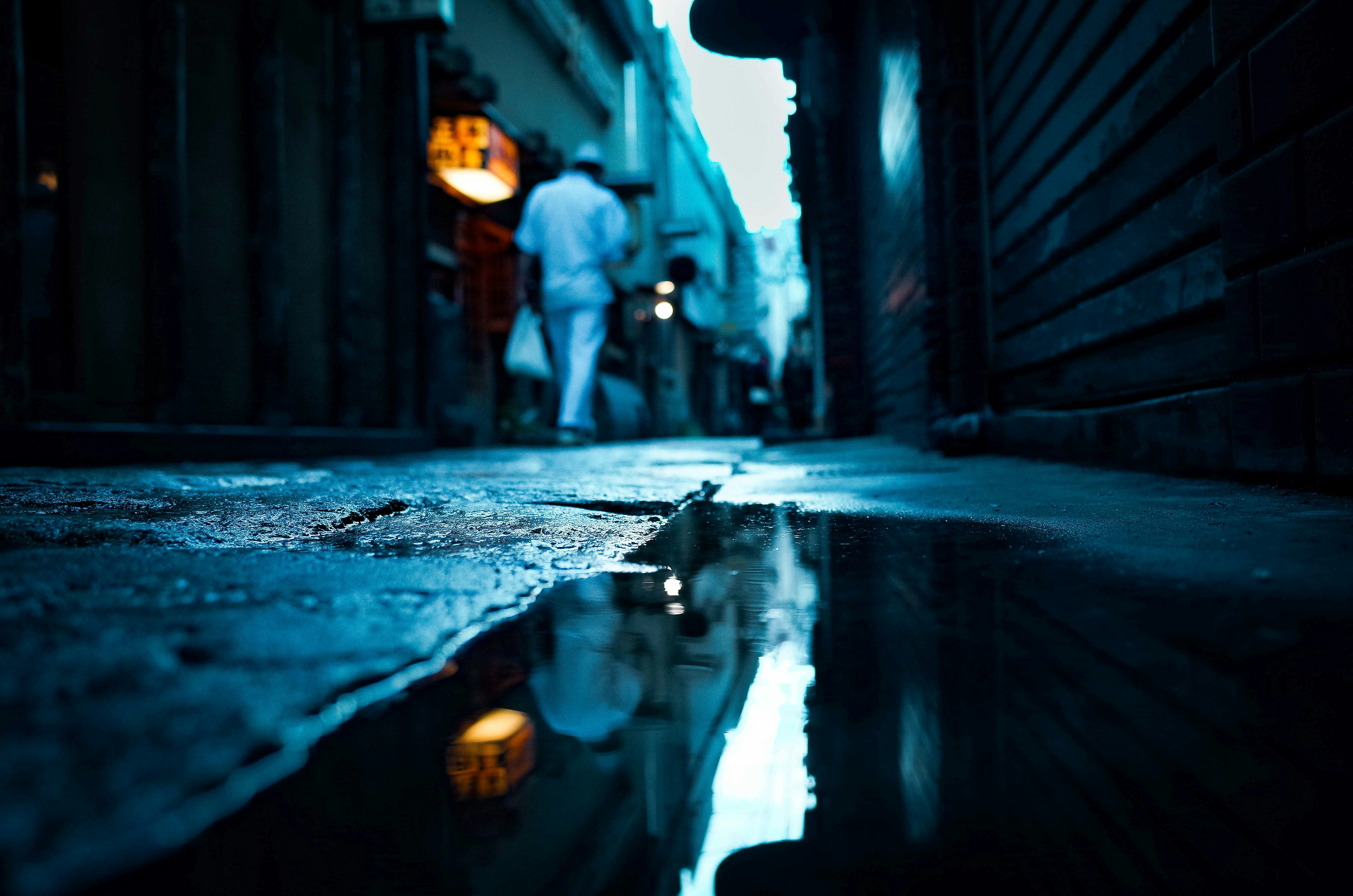 man in black jacket walking on street during daytime